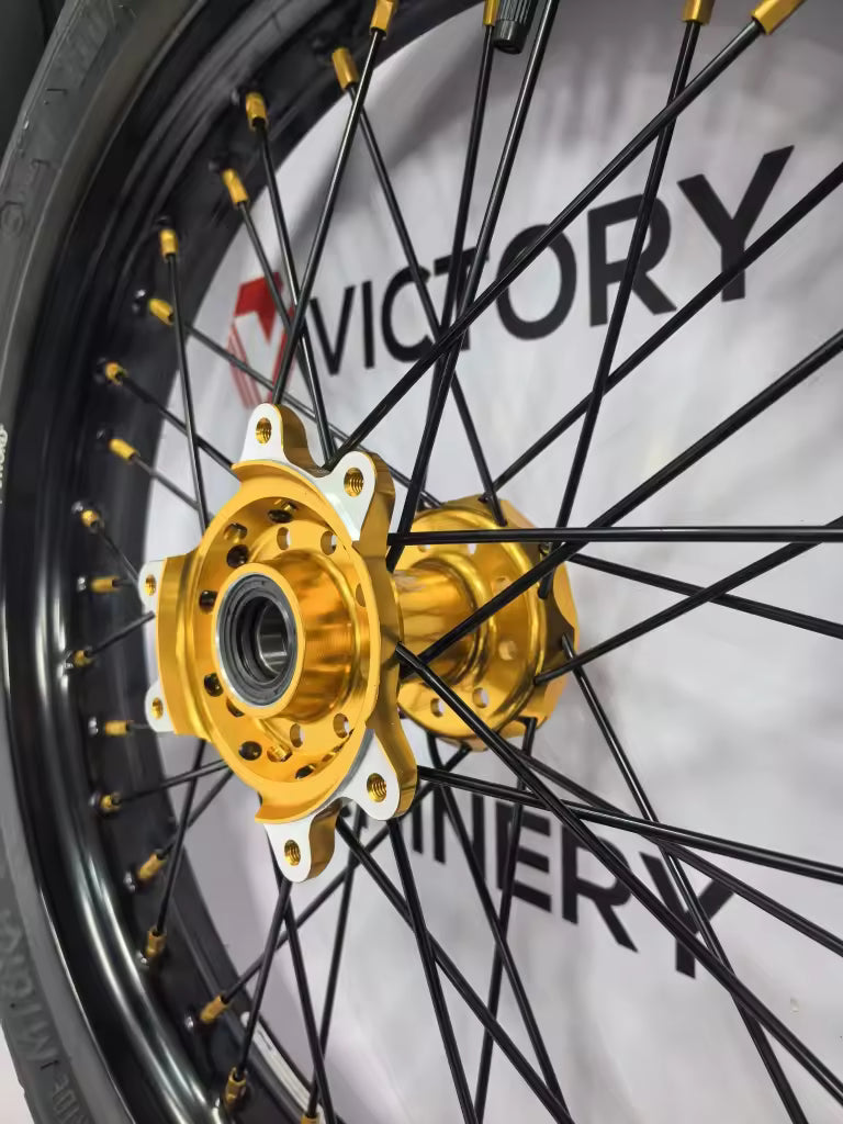 Customizable MXR Ultra Bee Supermoto Wheelset showcased with performance tires and stylish design on a patterned mat.